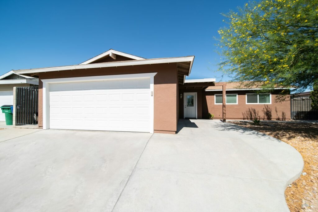 New concrete driveway in front of a single-story home