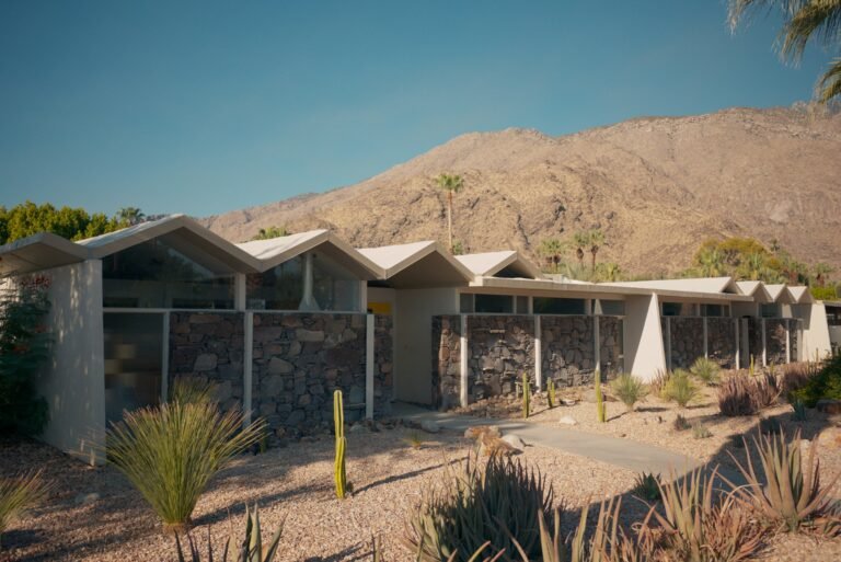 Mid-century modern home with desert landscaping and mountains