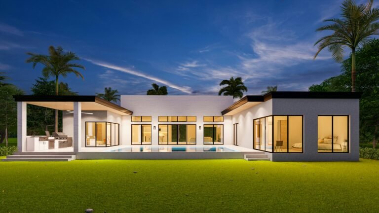 Modern single-story home with lit pool and lawn at dusk