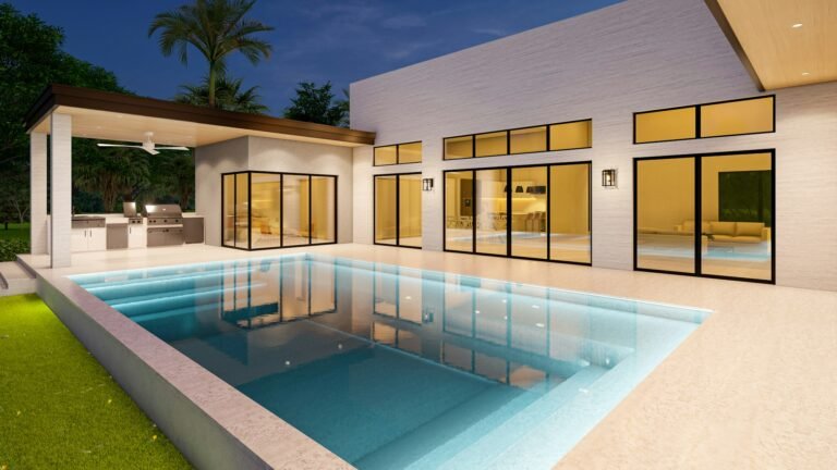Contemporary home with rectangular pool and glass walls at dusk