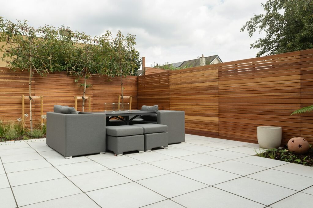 Large-format light porcelain tile patio with modern lounge set
